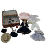 Collection of dolls clothing and a porcelain doll