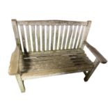 A weathered teak garden bench