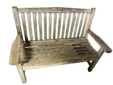 A weathered teak garden bench