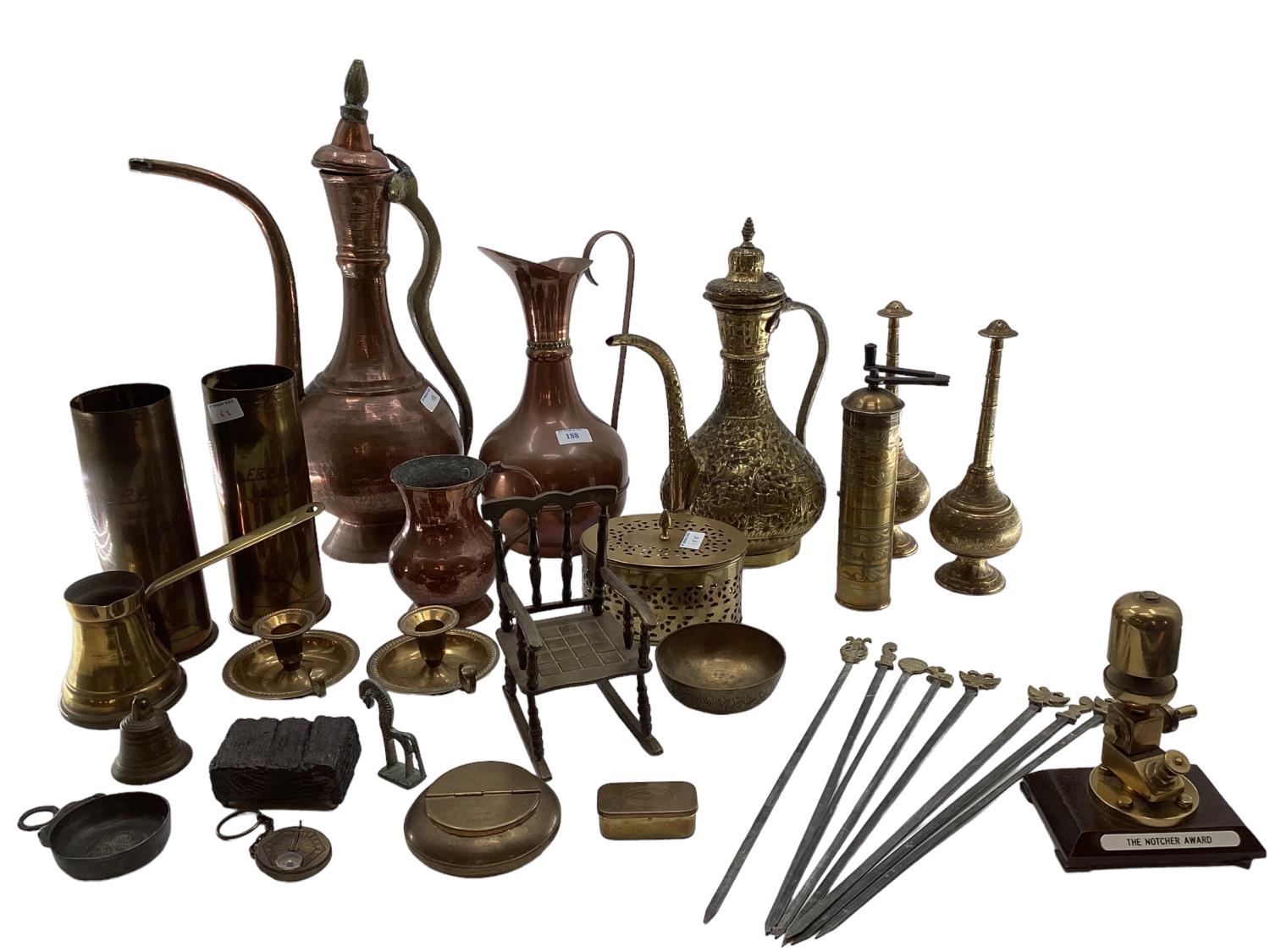 A collection of metalware to include Middle Eastern style ewers, trench art and other items