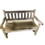 Two seater weathered garden bench, with a galleried ladder back