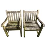 Pair of weathered garden armchairs