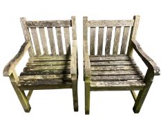 Pair of weathered garden armchairs
