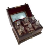 A Victorian mahogany six bottle decanter box with domed lid, six glass decanters with original