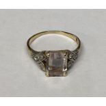 An 18ct gold, rose quartz set ring, with diamond set shoulders, size I