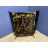 A decorative, Mid century fire screen, in the oriental taste with images of pagodas, open 82cm W x