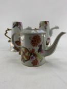 Dragon spout chocolate pots and a tea pot ex de Gournay showroom display, with marks and chips, in a