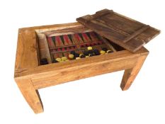 A rustic low table, with inset top and lid opening to reveal a games table and counters 74cm W x