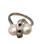 MIKIMOTO, A 14ct white gold double pearl cross over ring set with single line of alternating