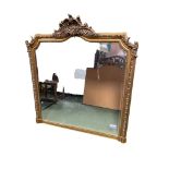 A large modern gilt framed wall mirror, with shell finial, 152H, 124W cm approx.