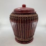 A large Chinese C19th style lacquered lidded storage har with ratan cover, 56cmH