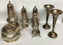 A collection of sterling silver and white metal items to include pepperettes and a pair of trumpet