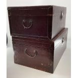 A near pair of Chinese C19th style lacquer trunks with fabric lined interiors and brass carry