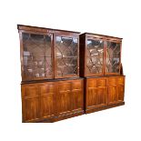 A pair of Georgian mahogany two part bookcases with moulded cornice, two glazed doors over two