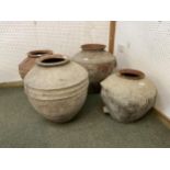 Four similar terracotta bulbous pots, tallest approx. 55cm H, all with some wear and rustic, see