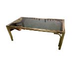 Modern brass and smoked glass coffee table, 118cn L x 63cmW; and a modern cream leather reclining