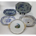 Four blue and white serving dishes together with a porcelain circular tray with gilt handles,