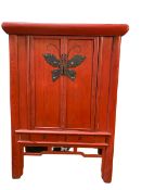 A C19th style Chinese red lacquer Wedding Cabinet with butterfly escutcheons with two drawers