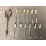 A Dutch silver apostle style spoon together with two sets of 6 Sterling silver coffee spoons, 175g