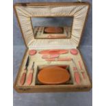 A Mid C20th manicure set, in faux leather box, complete with mirror