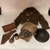 A World War II period military issue long hose gas mask with original haversack and accessories,