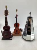 Three table lamps, a Ukulele, a violin and a conical panelled mirrored example, largest 65cm