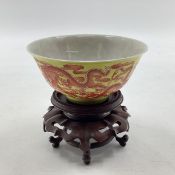A Chinese yellow ground bowl with stylised dragon decoration, flared rim, Qing dynasty, Qianlong