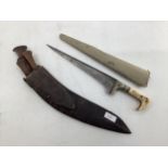 Early C20th Kukri knife in leather scabbard with two small additional knives together with a