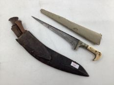 Early C20th Kukri knife in leather scabbard with two small additional knives together with a