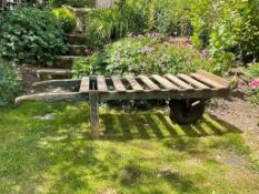 A large vintage hand barrow with wooden slat top with single wheel, and iron supports, 184 x 50 x