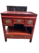 A C19th style Chinese hardwood cabinet, three short drawers over recess, belwo two drawers on square
