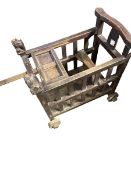 A late C19th/early C20th Style Chinese hardwood baby minder cart, yoke back with stylised lion