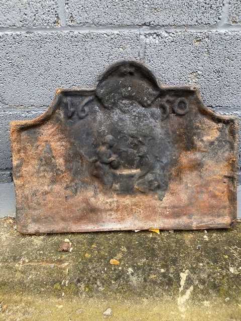 A heavy fireback and a quantity of brass and copper fireside items