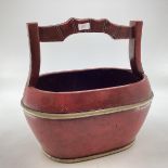 A Chinese 19th style lacquer and brass bound water bucket of oval form with stylised handle, 45 x 45