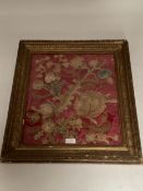 A glazed and framed C18th style silk panel with gilt thread decoration depicting leaves, flowers and