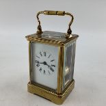 A Swiss gilt brass carriage clock, with visible escapement stamped made in Switzerland 17cm (in