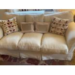 Pair of cream upholstered three seater sofas, 225cmL, with some wear, sold as seen (2 sofas)