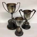 Two Sterling silver and one white metal miniature trophies on turned wooden bases