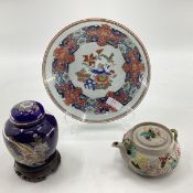 Three oriental style ceramic items to include a hand decorated dish, ceramic teapot on stand (3)