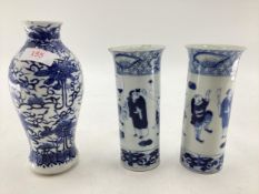 A pair of Chinese blue and white tube vases with flared rim and a blue and white baluster shaped