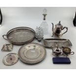 A collection of silver plated wares to include a white metal collared decanter, tray and other items