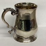 A Sterling silver mug, circular stepped foot and scrolling handle 10cm(h), by Holland Aldwinkle