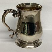 A Sterling silver mug, circular stepped foot and scrolling handle 10cm(h), by Holland Aldwinkle