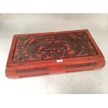 A large Chinese C19th style oblong lacquer box with stylised flora and fauna decoration, 60 x 35 x
