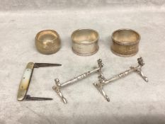 A Collection of sterling silver items to include Napkin ring, knife rests etc,