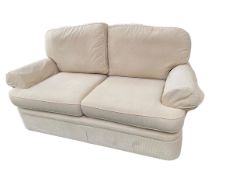 A two seater sofa win a cream corduroy style fabric