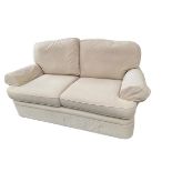 A two seater sofa win a cream corduroy style fabric