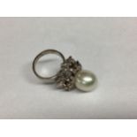 A modern and impressive pearl and diamond ring, size O