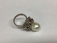 A modern and impressive pearl and diamond ring, size O