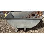 A galvanised metal feed or mash barrow